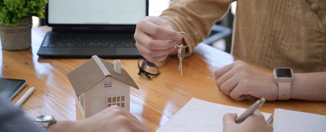 A stressed property buyer reviewing multiple documents, spreadsheets, and inspection reports at a desk, visually overwhelmed by conflicting information while making a high-stakes property decision.